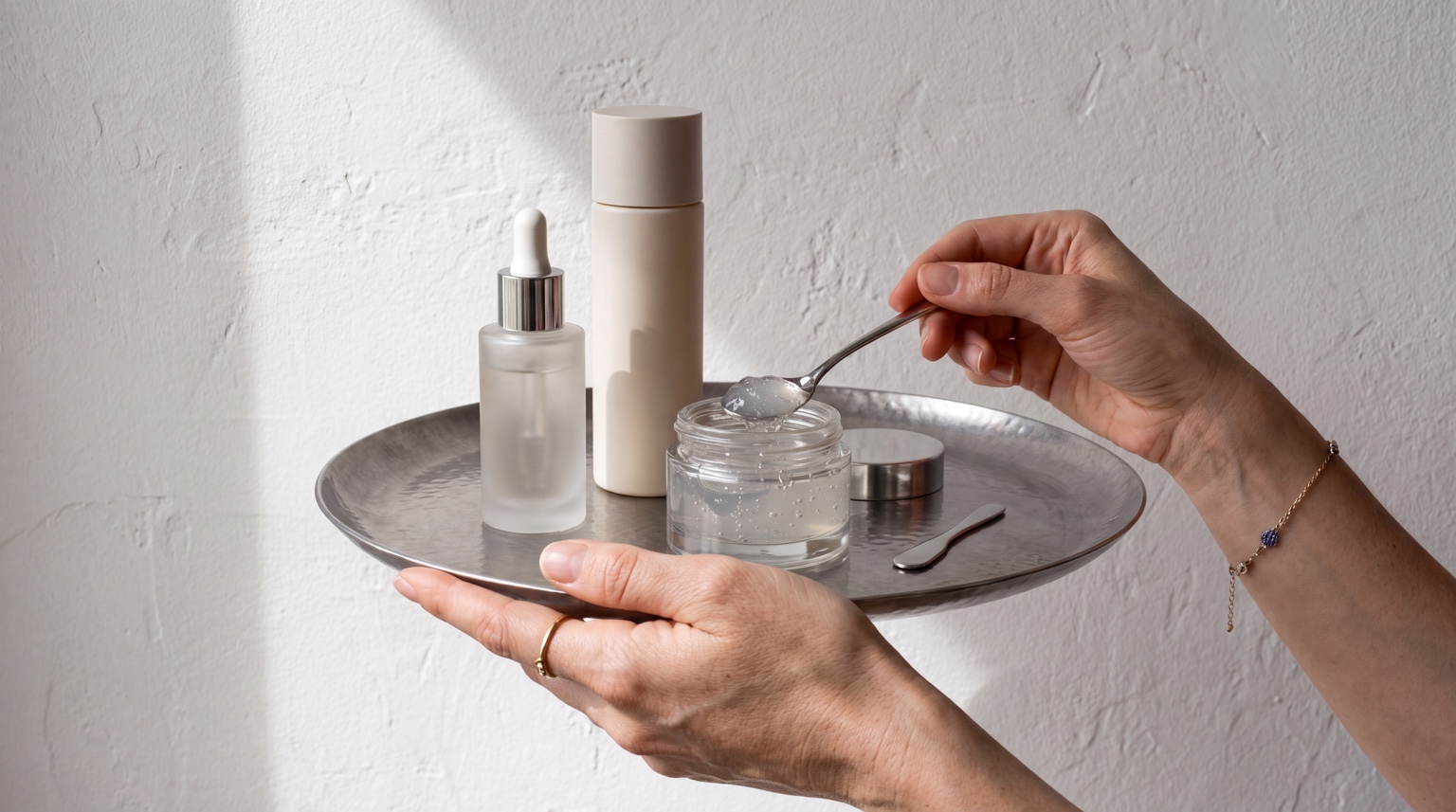 Minimal skincare products on silver tray